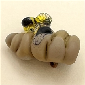 Mary Gaumond’s bee and hive studio glass button.