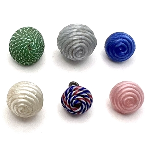 Six assorted ribbon overlay glass buttons.