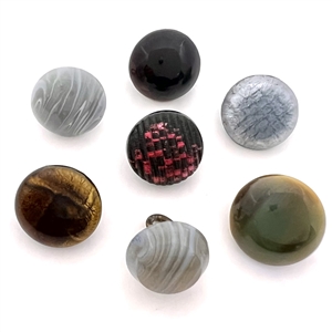 Seven glass buttons including rosette-shanked glass and others.