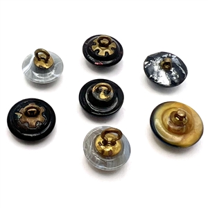 Seven glass buttons including rosette-shanked glass and others.