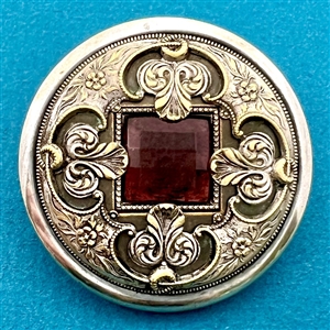 Gay 90’s type button with faceted purple glass “jewel.”