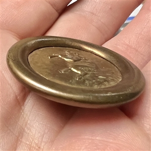 Stamped brass button of Pan piping.