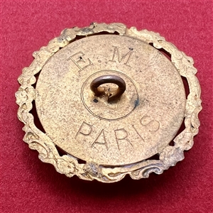 Carved pearl button of woman gathering with a net.