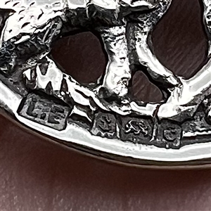 Hallmarked silver button of people with dogs.