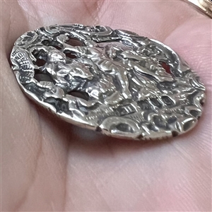 Hallmarked silver button of three women with a cherub.