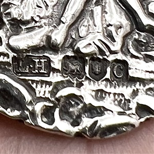 Hallmarked silver button of three women with a cherub.