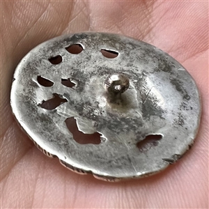 Hallmarked silver button of three women with a cherub.