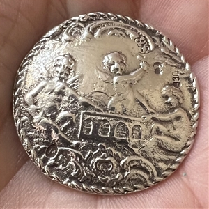 Hallmarked silver button of three cherubs.