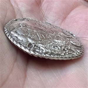 Hallmarked silver button of three cherubs.