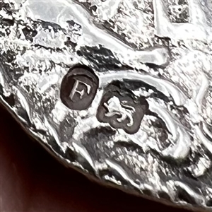 Hallmarked silver button of three cherubs.