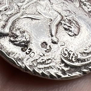 Hallmarked silver button of three cherubs.
