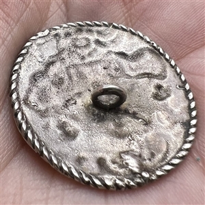 Hallmarked silver button of three cherubs.