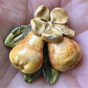 Painted sculptural plaster button of pears.