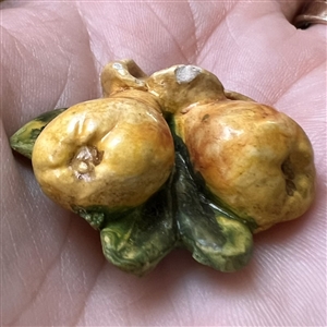 Painted sculptural plaster button of pears.