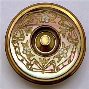Iridescent brown pearl button with incised design.