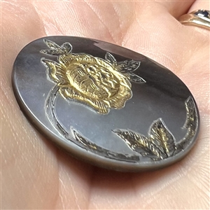 Pearl button with gold rose.