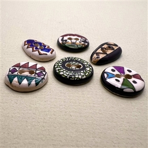 Six assorted hand-painted glazed ceramic buttons.