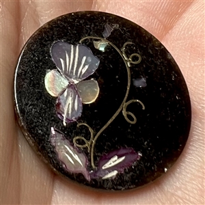 Horn inlay button of a violet.