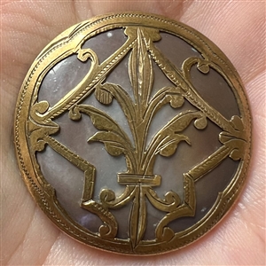 Iridescent brown pearl button with stylized brass fleur-de-lis design.