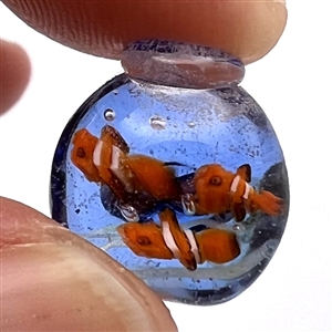Mary Gaumond studio glass button of fish in a fishbowl.