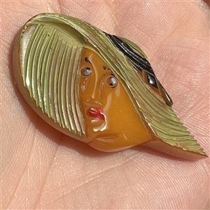 Realistic Bakelite button of a girl in a sun bonnet.