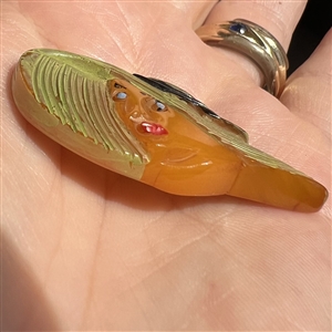 Realistic Bakelite button of a girl in a sun bonnet.
