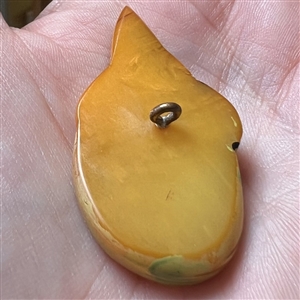 Realistic Bakelite button of a girl in a sun bonnet.