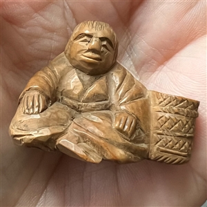 Seated man with basket netsuke.