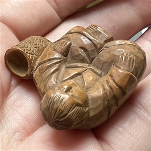 Seated man with basket netsuke.