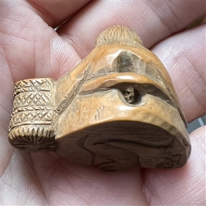 Seated man with basket netsuke.