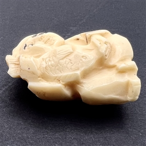 Man holding a fish netsuke.