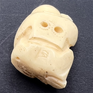 Man holding a fish netsuke.