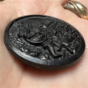 Black glass button of “Stag Hunt.”