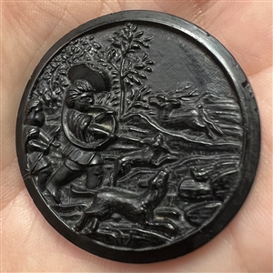 Black glass button of “Stag Hunt.”