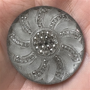 Lacy glass button with an interesting pattern.