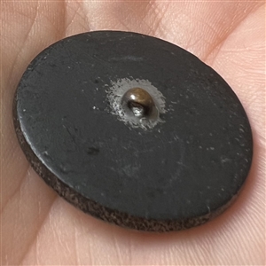 Lacy glass button with an interesting pattern.