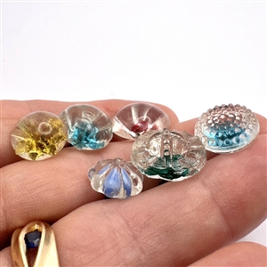 Six old glass radiant buttons.
