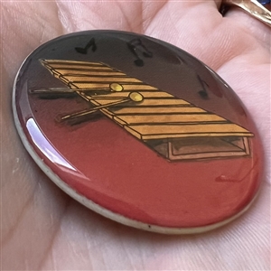Studio button of xylophone with notes by Shirley Burgess.