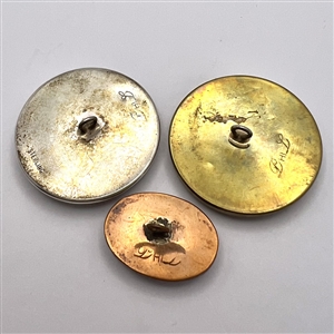 Three studio porcelain buttons by Phil Linley.