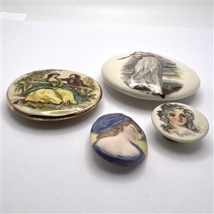 Four ceramic studio buttons by various artists.