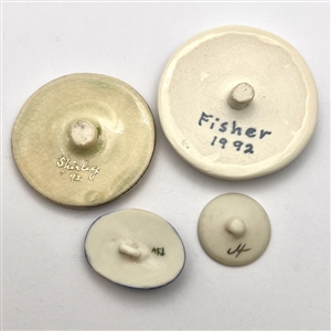 Four ceramic studio buttons by various artists.