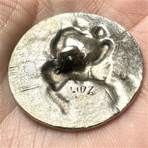 White metal metal button of man fighting a centaur by LIDZ.