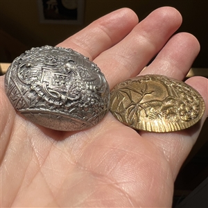 Two metal buttons of peacocks.