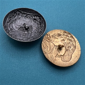 Two metal buttons of peacocks.