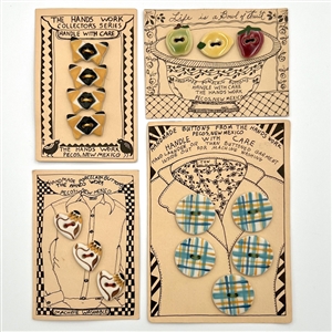 Four cards of “Hands Work” ceramic buttons of assorted objects and fruit.