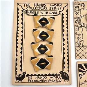 Four cards of “Hands Work” ceramic buttons of assorted objects and fruit.