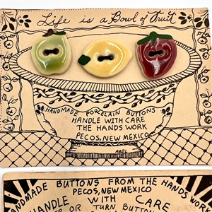 Four cards of “Hands Work” ceramic buttons of assorted objects and fruit.