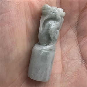 Carved jade button of a fabulous creature.