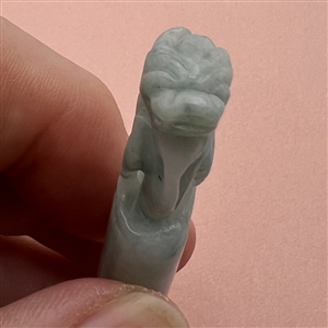 Carved jade button of a fabulous creature.
