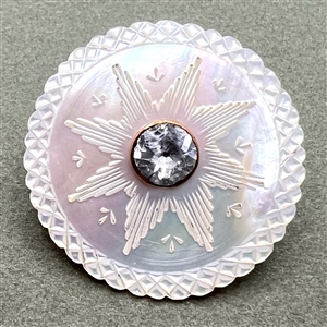 An 18th c. carved mother of pearl button with faceted paste center.